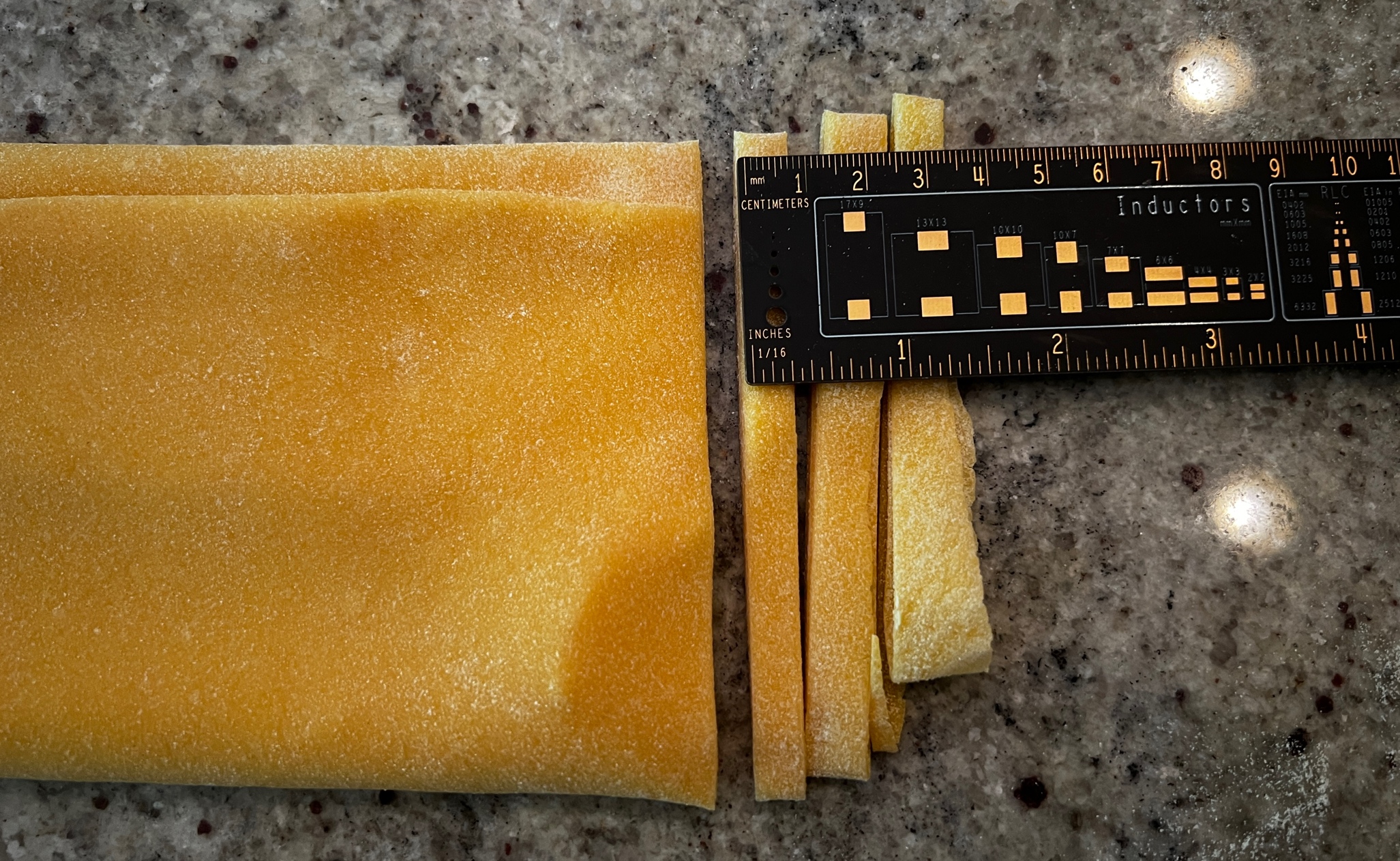A ruler next to a piece of yellow pasta

AI-generated content may be incorrect.